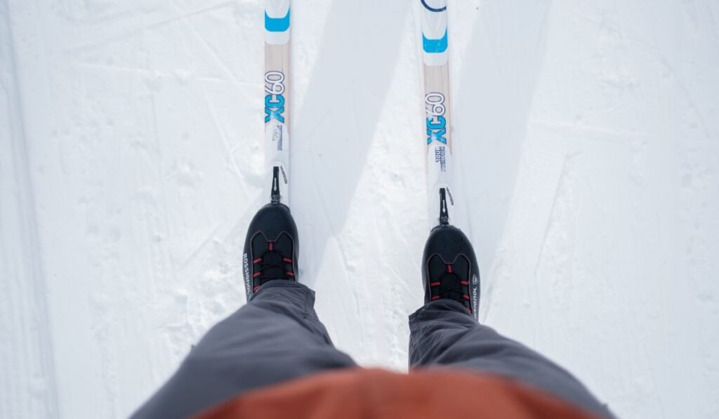 Skier in winter gear gliding down the slopes on skis